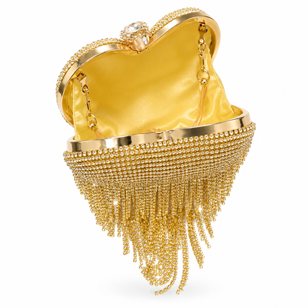 A gold evening clutch bag with a satin yellow interior, a rhinestone-embellished metal frame, and cascading rhinestone fringe chains, shown on a white background.