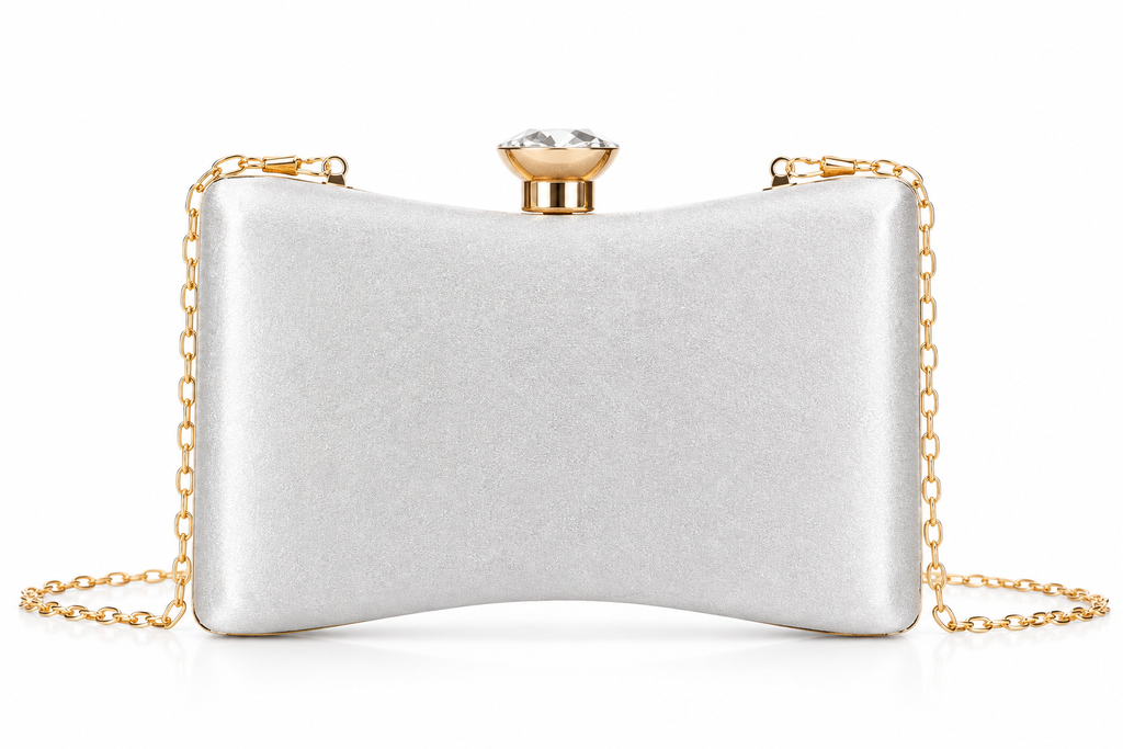 A silver satin clutch bag with a gold-tone chain strap and a rhinestone-embellished clasp, shown on a plain white background.