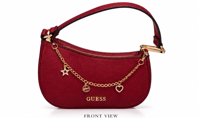 A red textured leather GUESS handbag with gold-tone hardware, featuring a gold chain charm with a star, a horse bit, and a heart, shown on a white background with 'FRONT VIEW' text below.